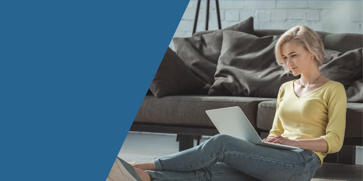 girl-sitting-on-floor-using-laptop