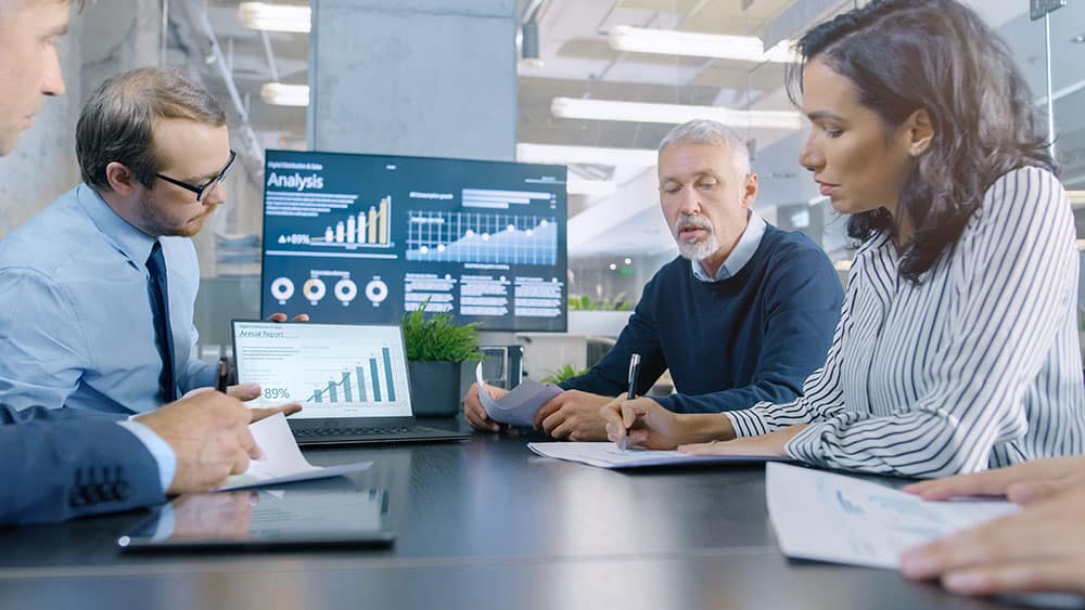 A team talking in front of a computer