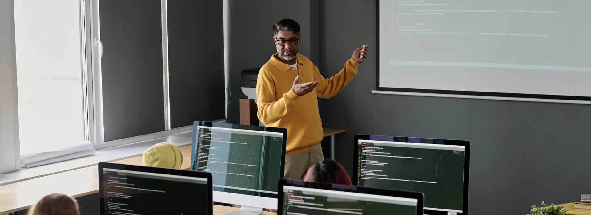 professor teaching to students in a classroom