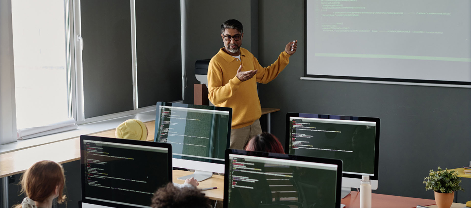 professor teaching to students in a classroom